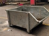 a dumpster that is sitting in the middle of a parking lot