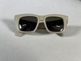 a close up of a pair of sunglasses on a white surface