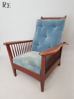 a chair with a blue cushion and a chair with a wooden frame