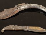 two knives that are sitting next to each other on a table