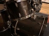 a drum set up in a recording studio with a microphone