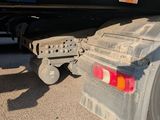 the rear end of a semi truck parked on the side of the road