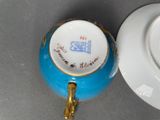 a tea cup and saucer sitting on a table