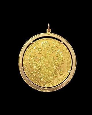 a close up of a gold coin on a black background