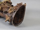 a close up of a piece of wood with a flower on it