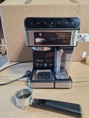 a coffee maker sitting on a table next to a cup