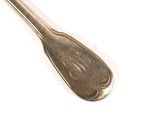 a spoon that is sitting on a white surface