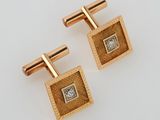 a pair of gold and diamond cufflinks