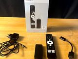 a remote control sitting on a table next to a box