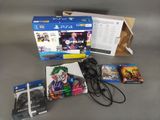 a box of games and a controller on a table