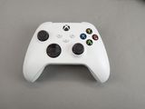 a close up of a white controller on a table
