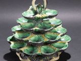 green and gold pine cone shaped dish on a black surface