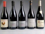 several bottles of wine are lined up on a table
