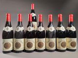 six bottles of wine are lined up in a row on a table
