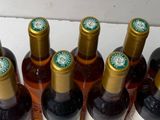 bottles of wine are lined up in a row on a table