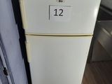 a white refrigerator with a number on it in a kitchen