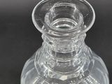 a clear glass vase sitting on a black surface