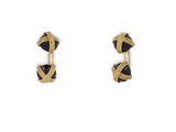 a pair of black and gold earrings on a white background