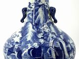 a blue and white vase with a mountain scene on it