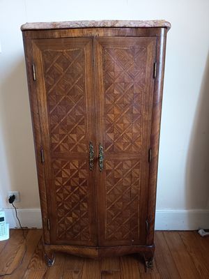 a wooden cabinet that is sitting on a hard wood floor