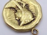an image of a gold coin with a picture of a woman on it