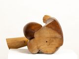 a wooden elephant sitting on top of a white box