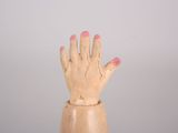 a wooden hand that is sitting on top of a table