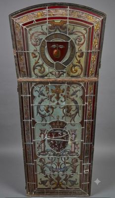a stained glass window with a coat of arms and a shield on it