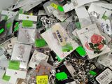 a pile of assorted key chains and tags on a table