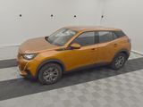 the orange car is parked in the garage on the checkered floor