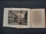 an open book with a drawing of a street in the middle of it