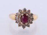 a close up of a gold ring with a ruby stone
