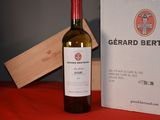 a bottle of wine next to a box on a table