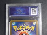 the pokemon card is in a clear plastic holder on a table