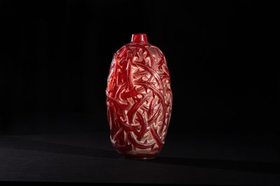 an image of a red vase on a black surface