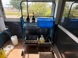 a blue trolley with two containers on it in a room