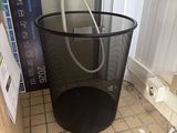 a trash can with a hose in it on the floor