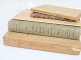 three books stacked on top of each other on a table