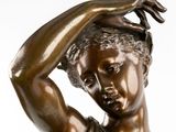 bronze statue of a woman holding her head in her hands