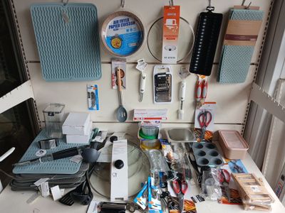 a table with many items on it and a phone hanging on the wall