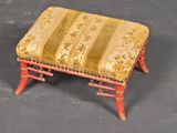 a small foot stool with a striped seat on it