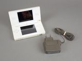 a white nintendo wii game console and a charger
