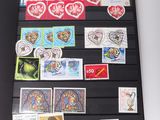an open book with stamps on it on a table