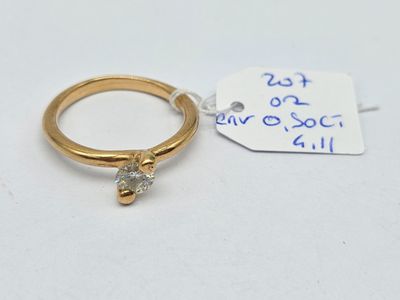 a gold ring with a diamond on it and a price tag