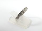 a close up of a silver ring on a clear piece of crystal