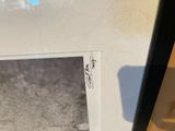 a black and white photo of a cat in a picture frame