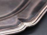 a close up of a silver plate on a table