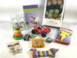 many toys and books on a table with a picture