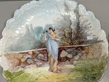 a plate with a painting of a woman on it