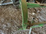a small green machine that is sitting in the dirt